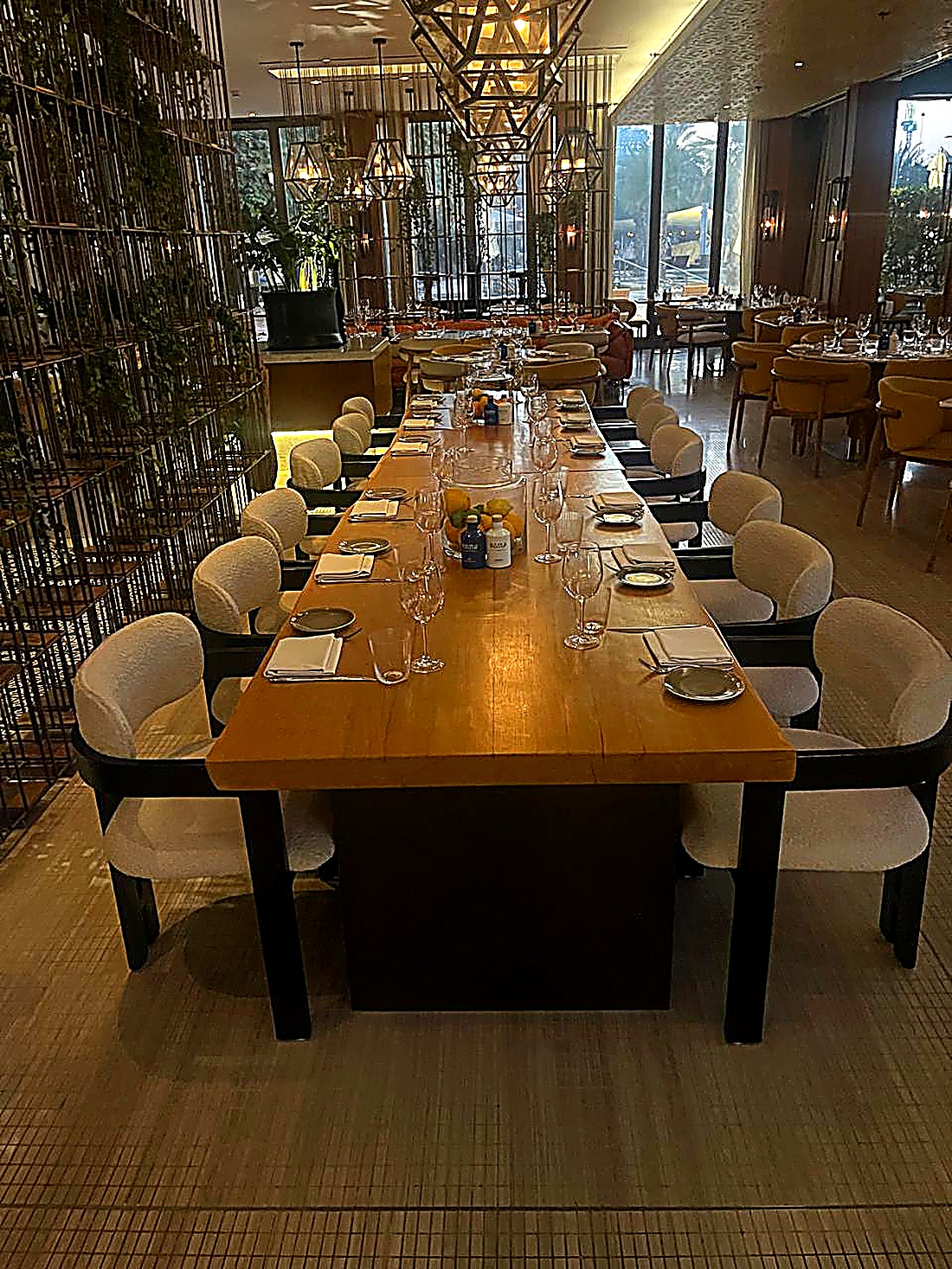 Long communal hotel restaurant dining table with bespoke chairs Dubai