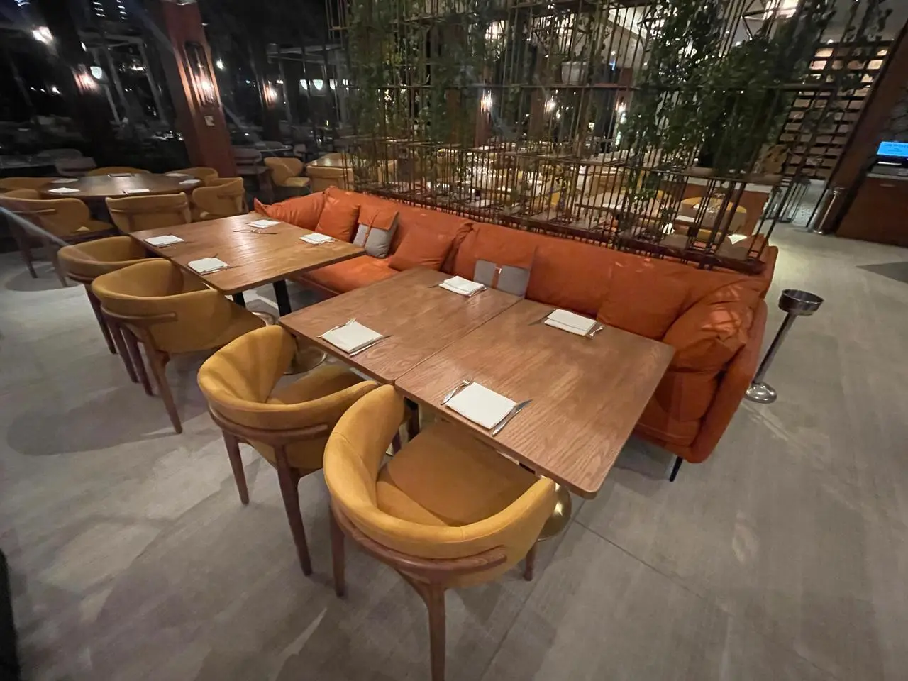Restaurant indoor seating with upholstered armchairs and timber dining tables at a premium Dubai restaurant