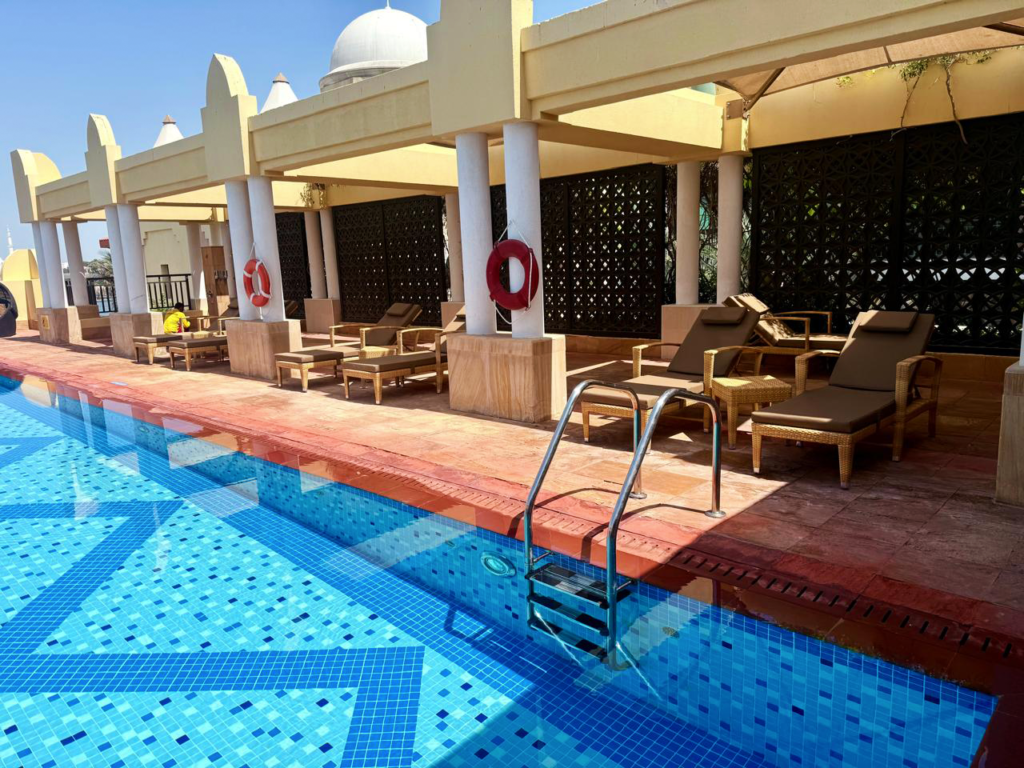 Poolside deck with custom outdoor loungers and canopy shading at a five-star resort, Abu Dhabi